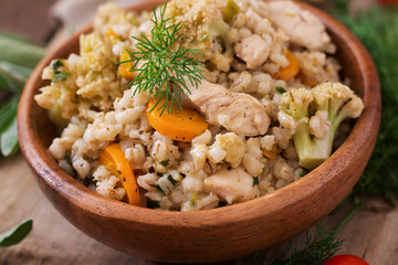 Tasty pearl barley porridge with vegetables and chicken