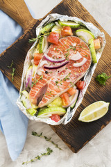 Raw salmon steak in a foil boat