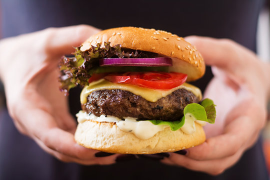 Big Sandwich - Hamburger Burger With Beef, Cheese, Tomato And Tartar Sauce In Female Hands