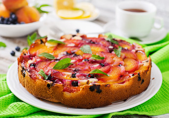 Delicate biscuit pie with peaches and blueberries.