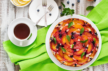 Delicate biscuit pie with peaches and blueberries. Top view
