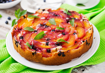 Delicate biscuit pie with peaches and blueberries.
