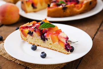 Delicate biscuit pie with peaches and blueberries.