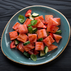 Plate with grilled watermelon and vegetables salad, top view