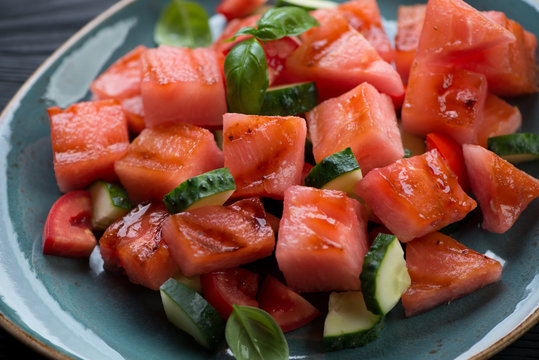 Closeup of grilled watermelon, tomato and cucumber salad