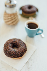 Breakfast in cafe with chocolate donut and coffee