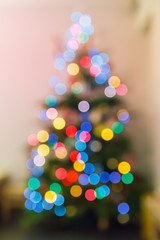 Defocused christmas tree full of colorful lights