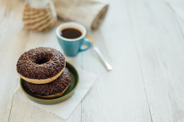 Breakfast in cafe with chocolate donut and coffee