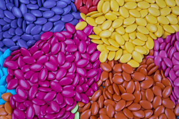 Colorful chocolate buttons, blue, yellow and pink use for designer