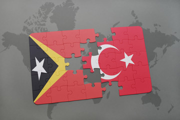 puzzle with the national flag of east timor and turkey on a world map background.