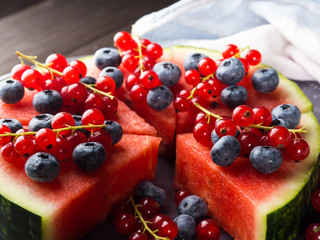 Watermelon cake with berries on rustic table