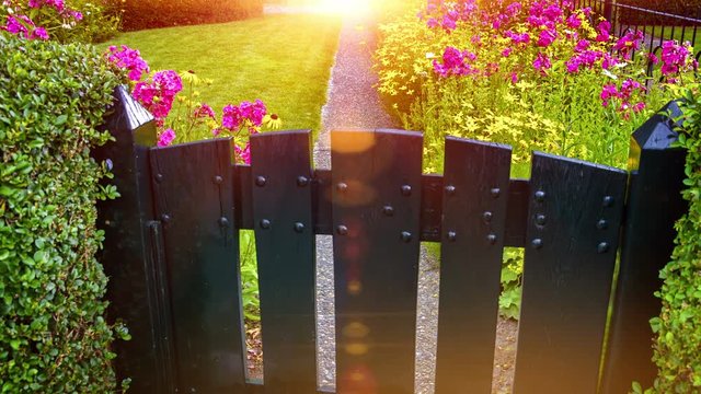 Dolly shot of country house garden with colorful flowers and green lawn. 4k