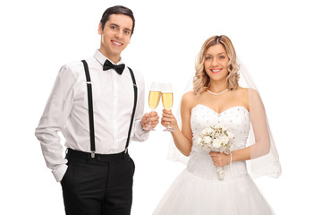Young bride and groom making a toast