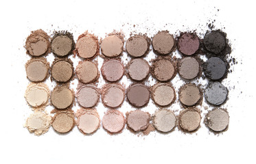A broken neutral colored eye shadow make up palette isolated on a white background © beckystarsmore
