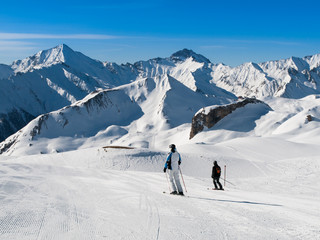 Fototapeta na wymiar Sunny winter day in alpine ski resort with blue sky and bright white snow, Ischgl and Samnaun, Silvretta Arena, Austria - Switzerland