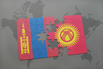 puzzle with the national flag of mongolia and kyrgyzstan on a world map background.