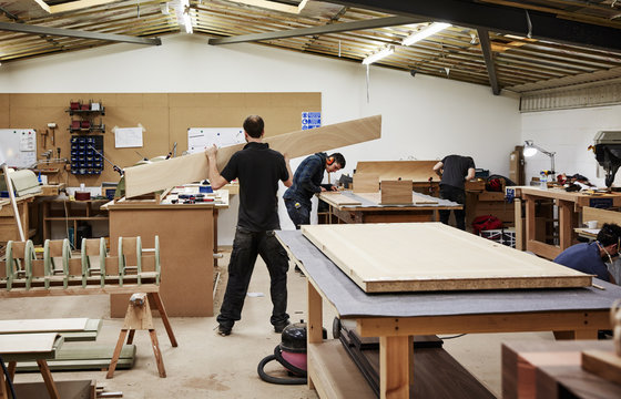 A furniture workshop making bespoke contemporary furniture pieces using traditional skills. Two men working with wood