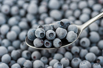 teaspoon with frozen blueberries