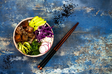 Hawaiian tuna poke bowl with seaweed, avocado, red cabbage, radishes and black sesame seeds