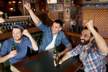 happy male friends drinking beer at bar or pub