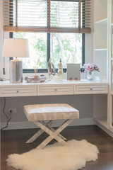 white dressing table and chair with women's accesories