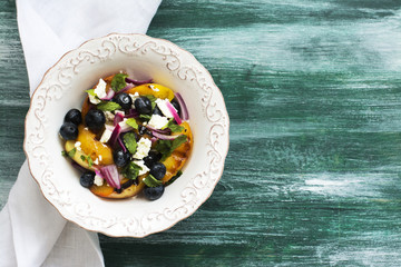 Summer salad with grilled peaches, blueberry and feta cheese