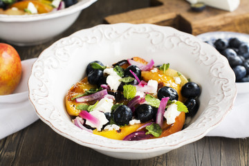 Summer salad with grilled peaches, blueberry and feta cheese