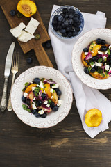 Summer salad with grilled peaches, blueberry and feta cheese