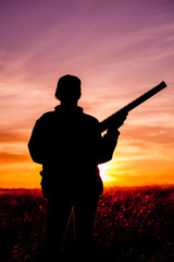 Woman hunter Silhouetted at Sunset