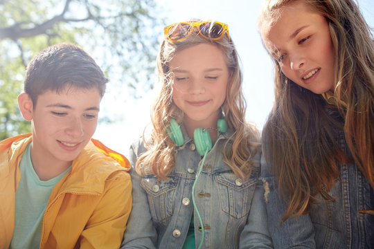 three happy teenage friends headphones