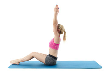 Obraz premium Young woman exercising on mat