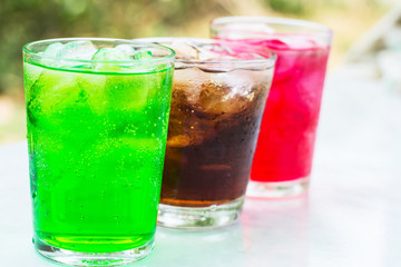Fototapeta na wymiar soft drink in a glass with ice cubes