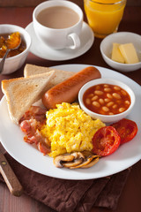 full english breakfast with scrambled eggs, bacon, sausage, bean