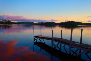 old pier in a lake at the sunset in maine - united states of america - Powered by Adobe