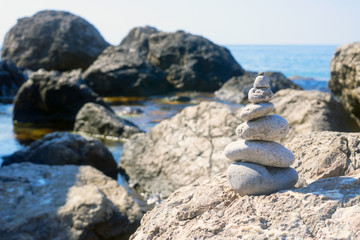 Small pyramid is among the large stones near the Black sea.