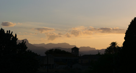 Fototapeta premium Rural church with mountain sunset