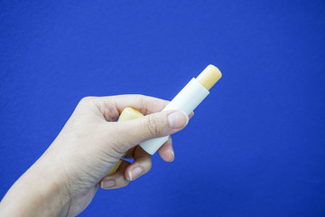 Hold a lip balm with woman hand