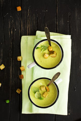 Green gazpacho soup in enamel mugs