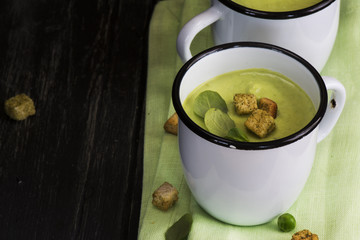 Green gazpacho soup in enamel mugs