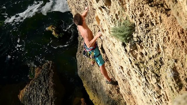 Extreme Climber With Equipment Climbs On A Rock
