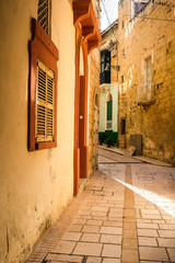 Valletta iconic narrow city streets at sunset