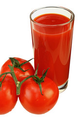 Glass of tomato juice and three ripe tomatoes