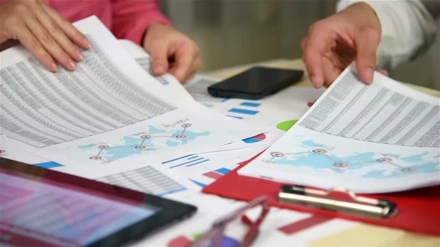 Business Employees Stack Up Annual Reports On The Table