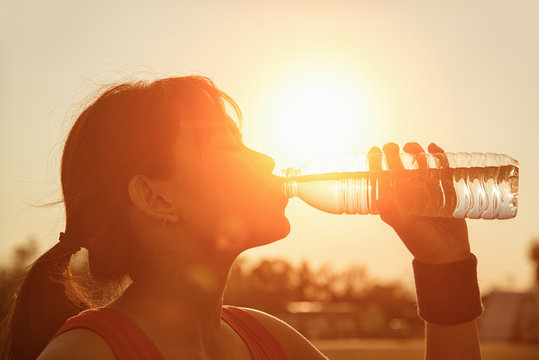 Female Drinking A Bottle Of Water