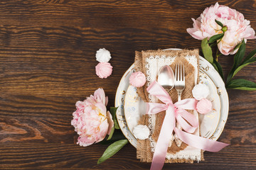 Obraz na płótnie Canvas Tableware with light pink peonies and meringues