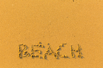 Beach - inscription on golden sand.