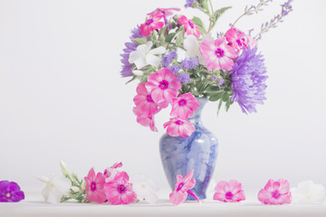  flowers in a vase on white background