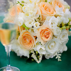 bridal bouquet and glass of champagne