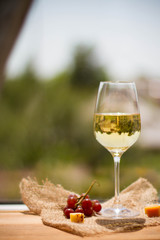 Wine, grape and cheese on wooden table
