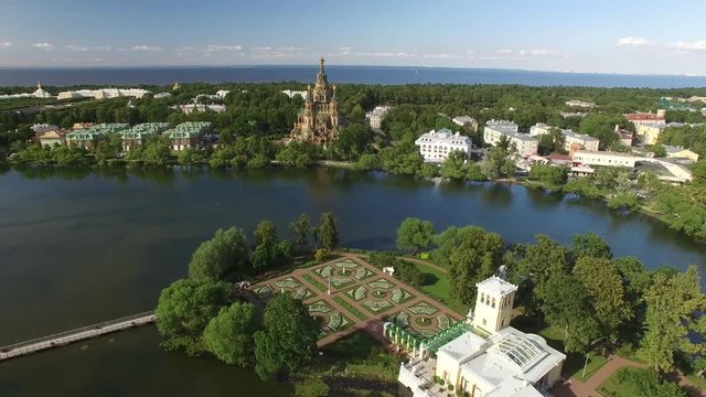 Top aerial view of beautiful Peterhof palace and grand cascade. Sparkling fountains. Golden statues. Unique aerial drone flight. Warm sunny day. 4K footage